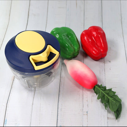 Chopper with its container and sharp stainless steel blades for vegetables.