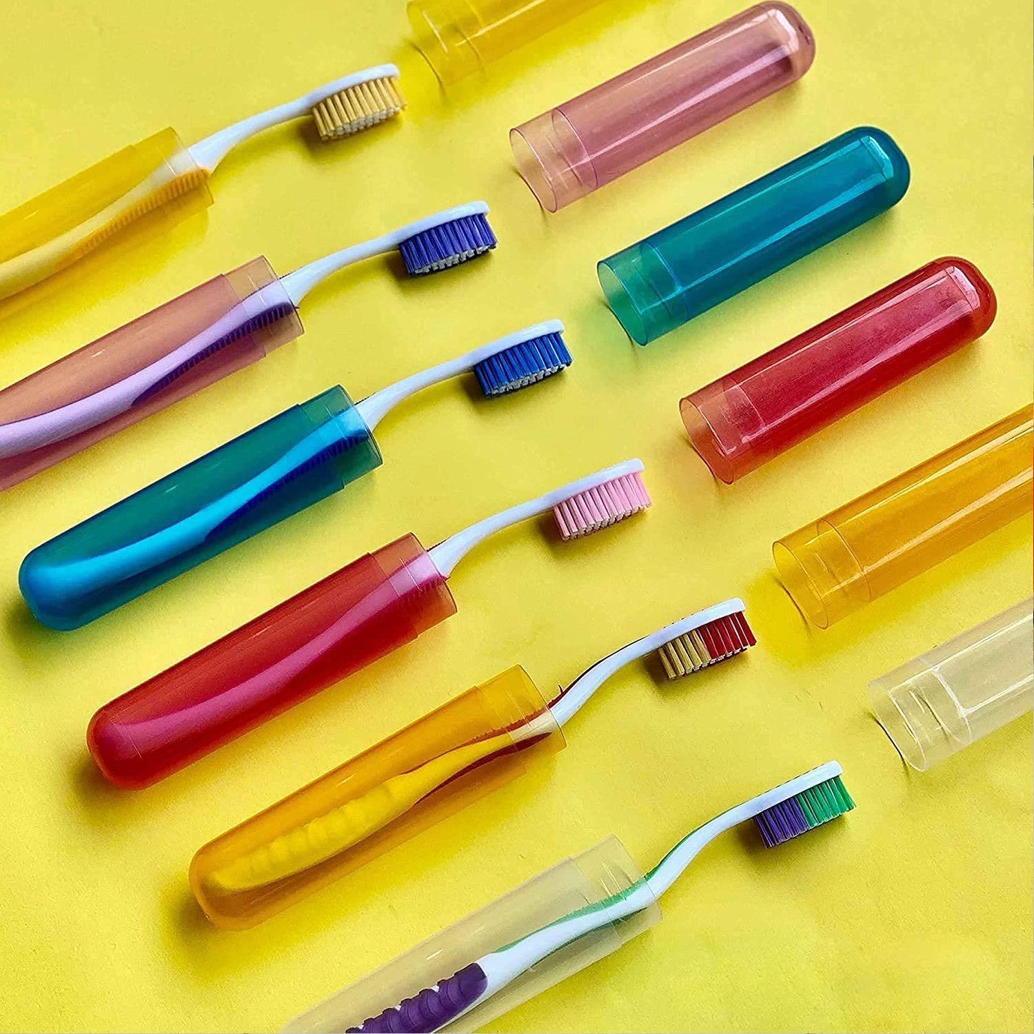 A manual toothbrush securely stored inside a clear plastic travel cover.
