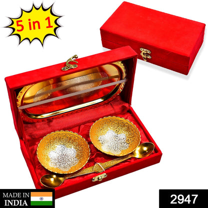 Close-up of the exquisite gold and silver plated brass serving set, featuring bowls and spoons.