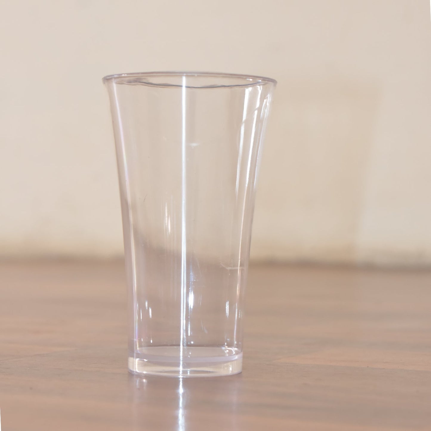 Stack of transparent plastic water glasses for compact storage.